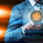 Business, Technology and Internet Concept - Businessman pressing E-Commerce Button on virtual Screens