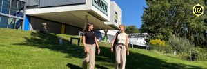 Zwei Studierende im Park vor dem Hauptgebäude der FH CAMPUS 02