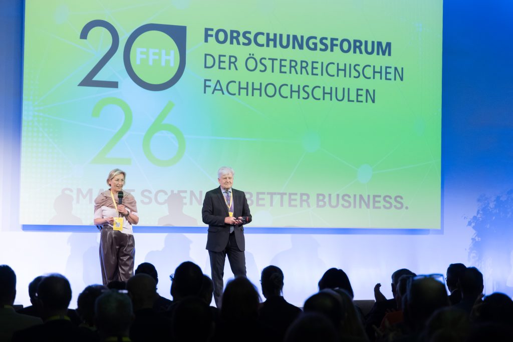 Personen begrüßen Gäste auf der Bühne im Europasaal